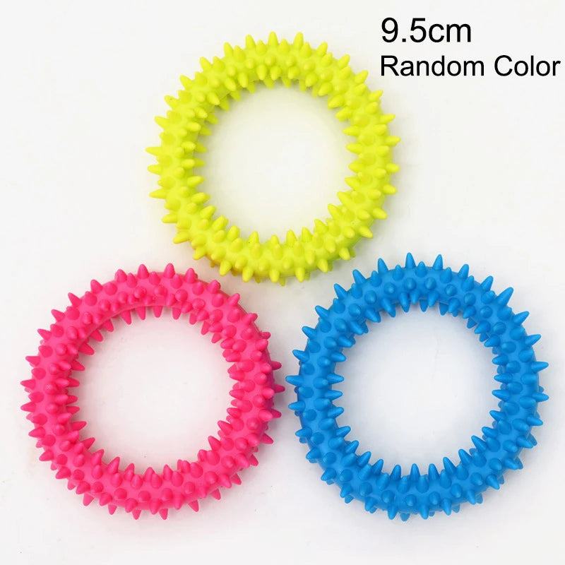 Three rings of squeaky chew toys for dogs in yellow, pink, and blue.