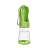 A green 2-in-1 portable pet water and food dispenser with a clear glass reservoir and a silicone strap.