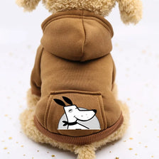A brown fleece dog sweatshirt with a hood and a patch featuring a cartoon rabbit face.