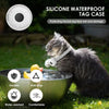 A gray cat wearing a silicone waterproof tag case on its collar near a bowl outdoors.