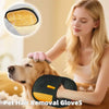 A woman is using a black pet hair removal glove on a golden retriever dog.