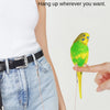 A hand is holding a yellow and green parrot hanging from an adjustable traction rope.