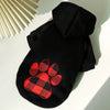 Black reversible plaid winter pet jacket for dogs with a paw print design