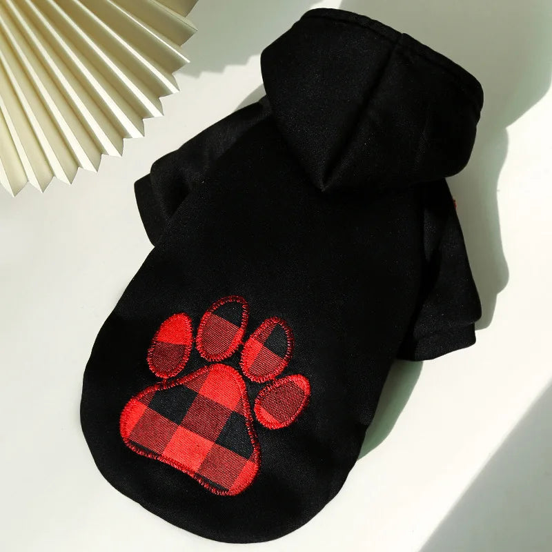 Black reversible plaid winter pet jacket for dogs with a paw print design