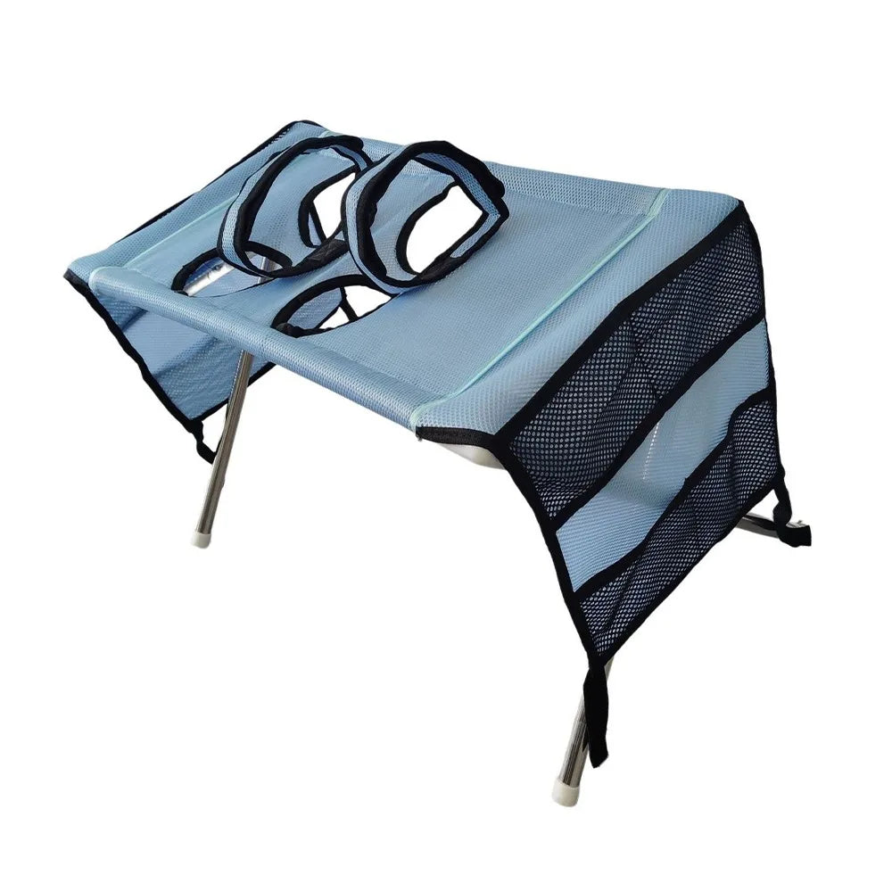A light blue foldable pet grooming hammock with black mesh netting and straps.