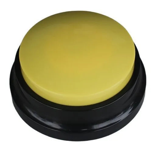 A round, yellow button with a black base for dog training.
