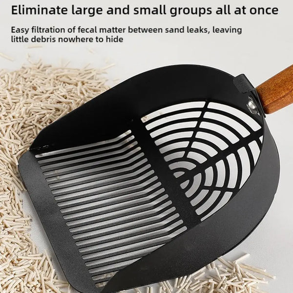 A black stainless steel litter scoop with a wooden handle is shown over a bed of light-colored straw.