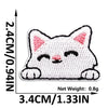 White embroidered cat patch with black details on a white background