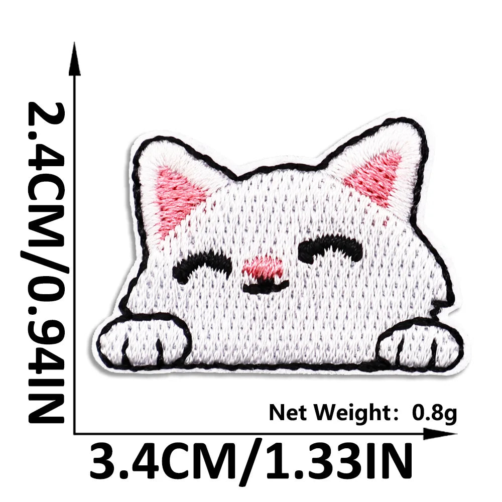White embroidered cat patch with black details on a white background