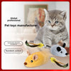 A fluffy gray kitten is sitting next to a yellow squeaky mouse toy and a gray mouse toy.