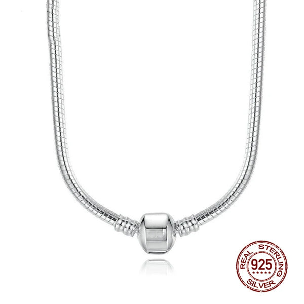 A silver snake chain necklace with a heart charm displayed against a white background.