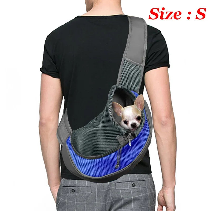 A person is wearing a gray breathable dog sling carrier with a small dog inside, shown from the back.