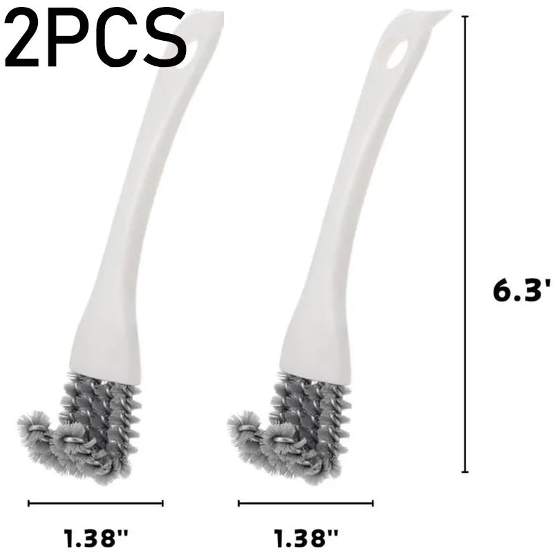 Dos cepillos de limpieza blancos con cerdas grises junto a una regla de medición.
