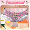A cozy double-layer fleece hammock for small pets is shown inside a wire cage with bedding and a small rodent.
