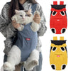 A fluffy white and brown cat is being held in a red cycling walking pet carrier for cats.