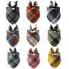 A collection of plaid dog bandanas in various colors and patterns, folded for display.
