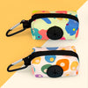 A colorful, patterned fabric pouch with a black zipper and metal clip used as a stylish dog poop bag holder.