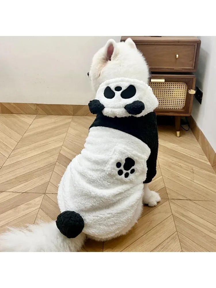 A white and black fleece dog coat with a panda design featuring black patches on the body and ears.
