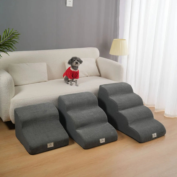 Gray washable non-slip pet stairs placed on a wooden floor next to a light-colored sofa.