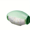 A reusable lint roller in light green with a clear window showing lint.