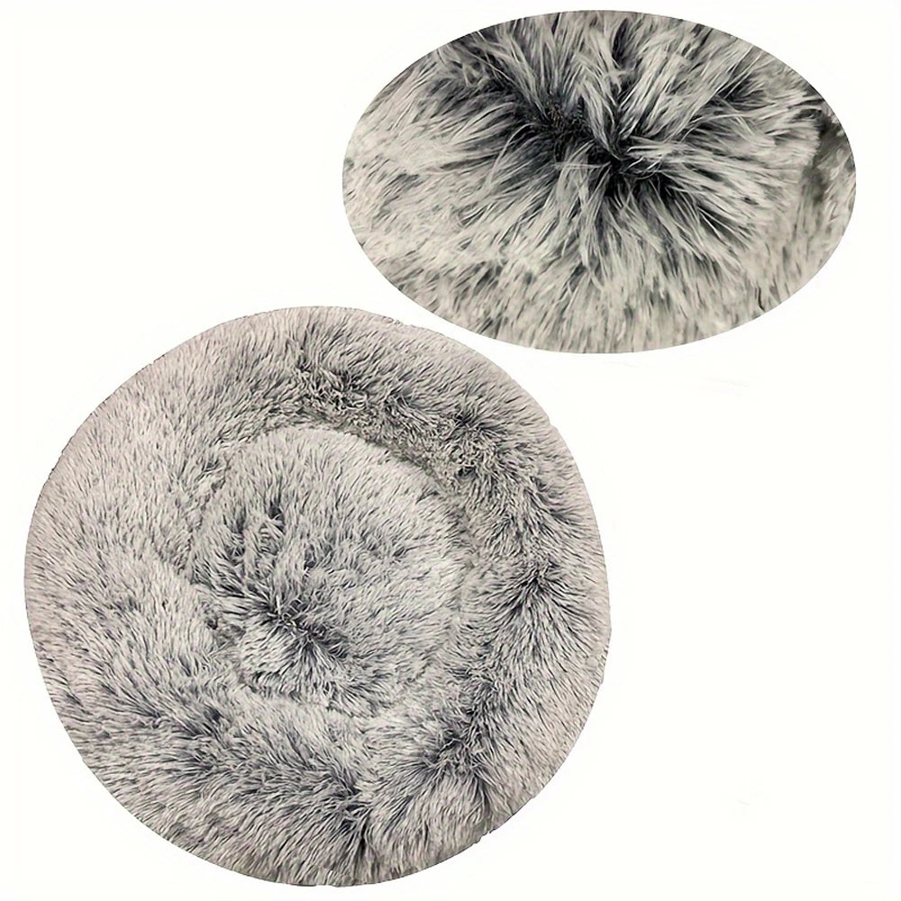 A round, fluffy gray pet bed with a textured, removable cover.