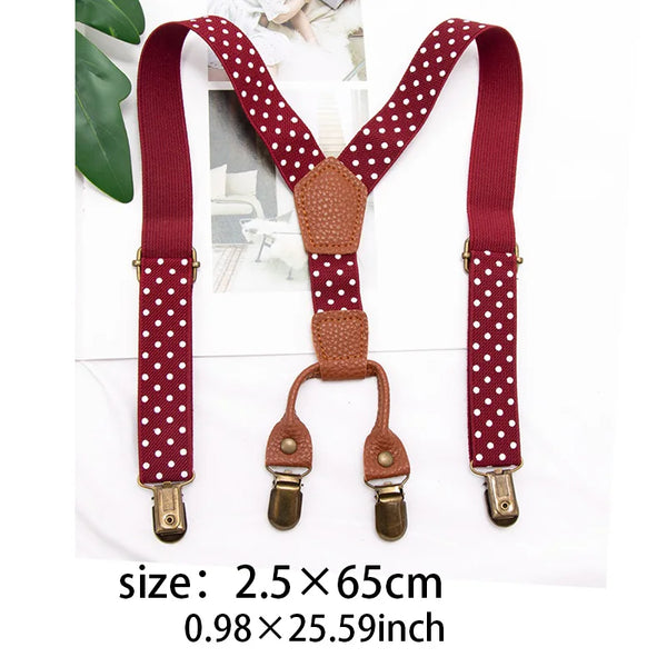 A pair of maroon and white polka dot adjustable clip-on suspenders for kids displayed on a white background.