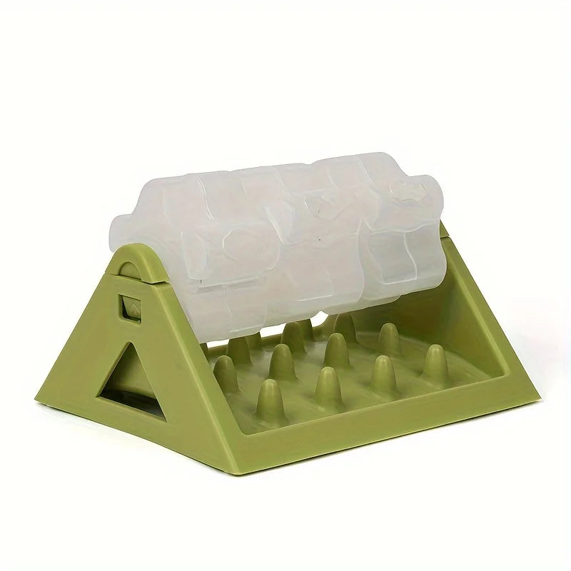 A light green interactive dog food puzzle dispenser with a clear silicone food tray and multiple feeding nozzles.