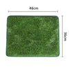 A rectangular green artificial grass mat measuring 46cm by 36cm for dog use.