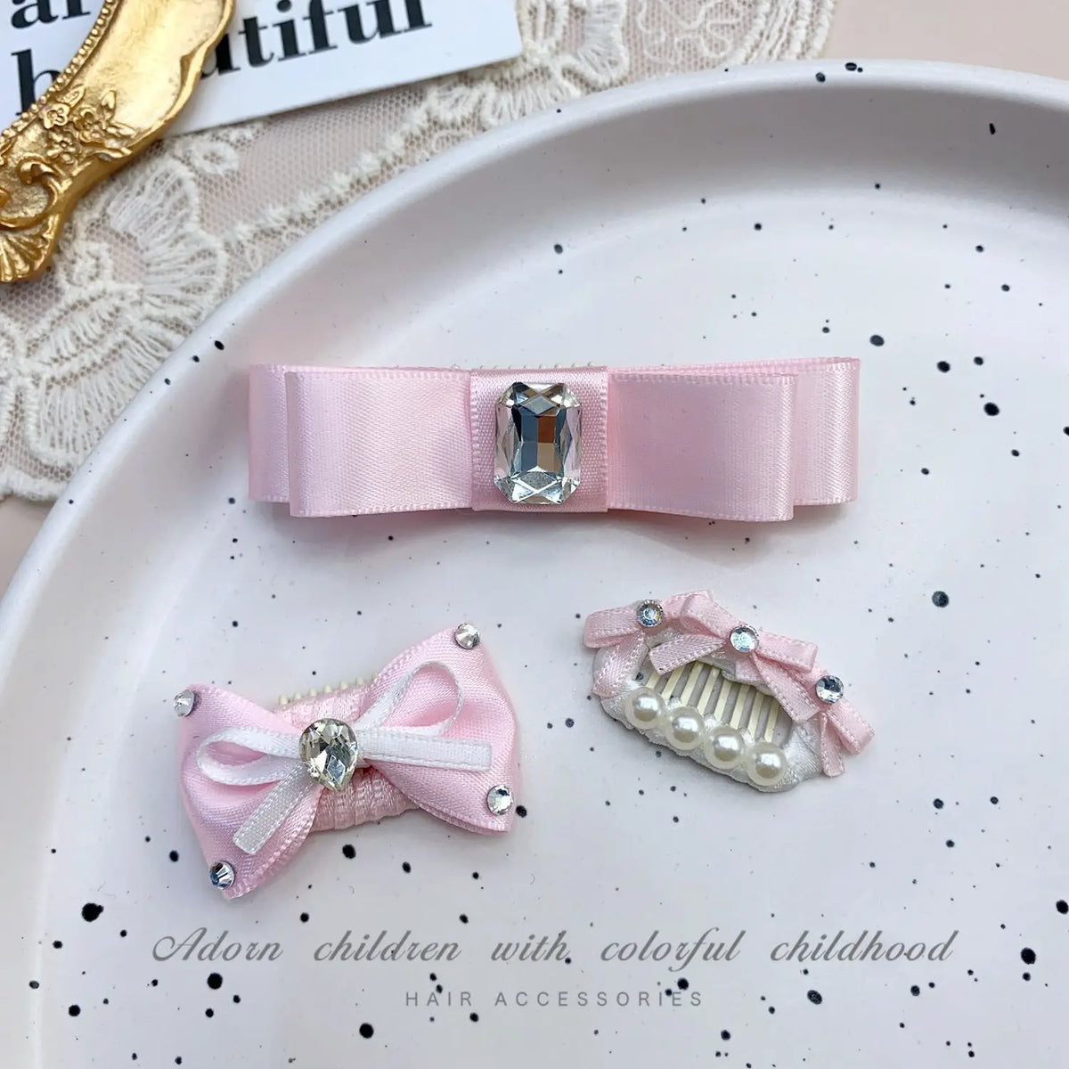 Pink bow hair accessory featuring a rhinestone and pearl accent for children's hair