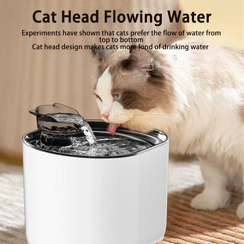 A domestic cat is drinking water from a white cat head flowing water fountain bowl.