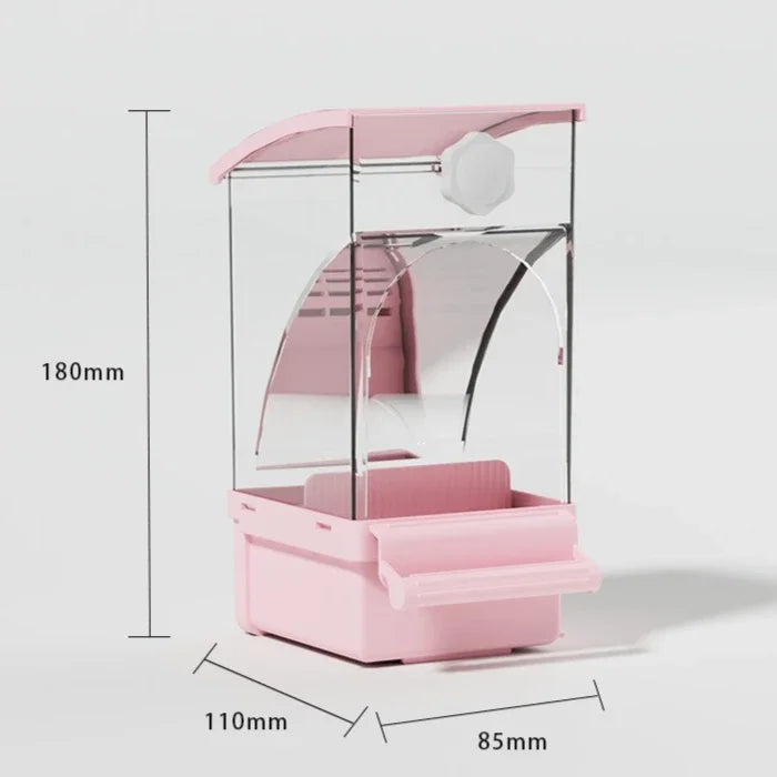 A pink automatic parrot feeder with a clear dome and a separate husk compartment.