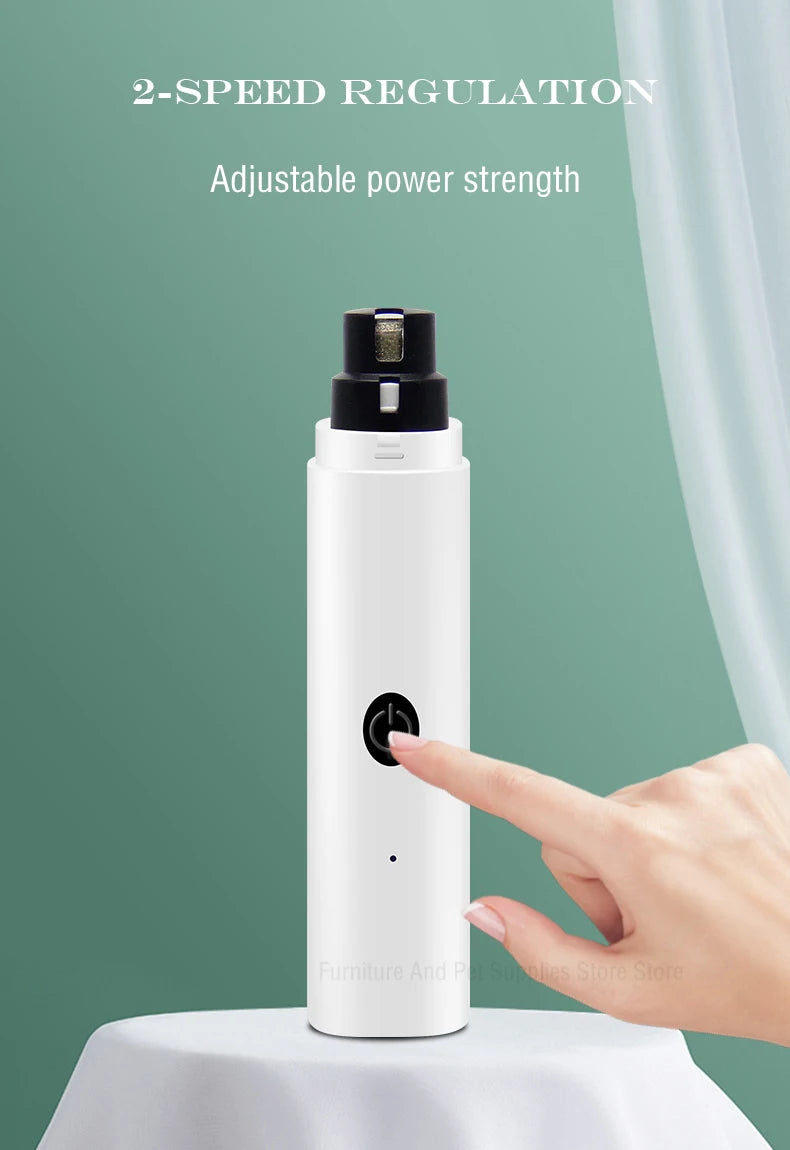 A white rechargeable electric dog nail grinder with a black cap is shown on a white surface.