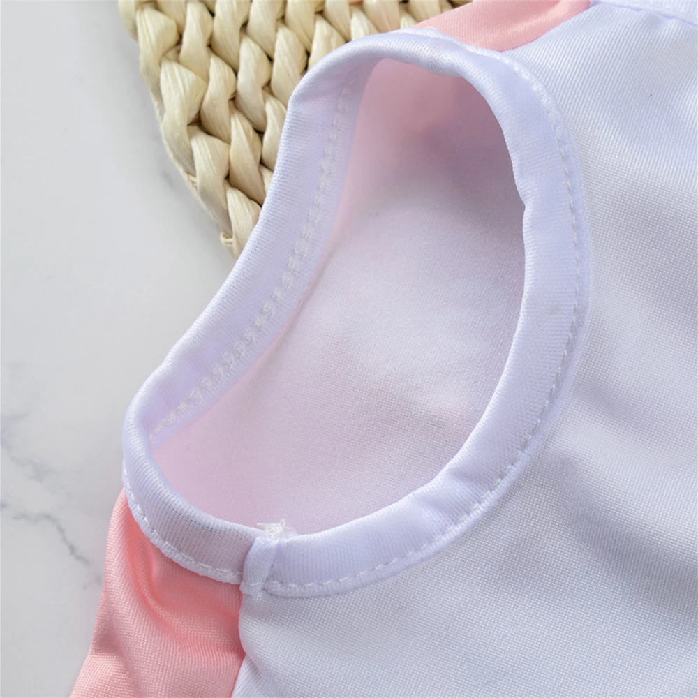A pink and white sleeveless pet vest for small dogs or cats, shown from the chest area.