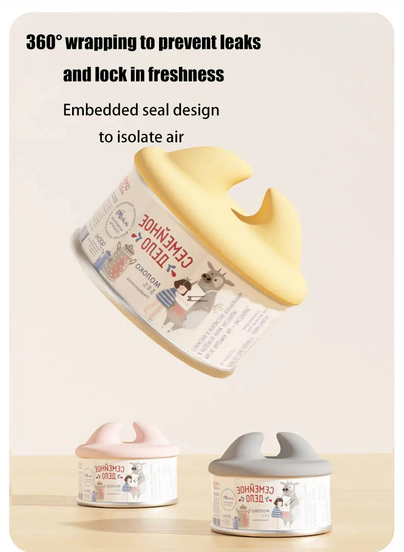 A yellow silicone pet can opener and feeding spoon with a sealing lid shown next to its open version.