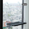 Black suction cup window hammock bed suspended by thin wires in a window frame.
