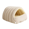 A beige plush cat cave bed with ribbed exterior and a removable inner lining.