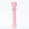 A pink long-handled pet food dispensing spoon with a cat head design.