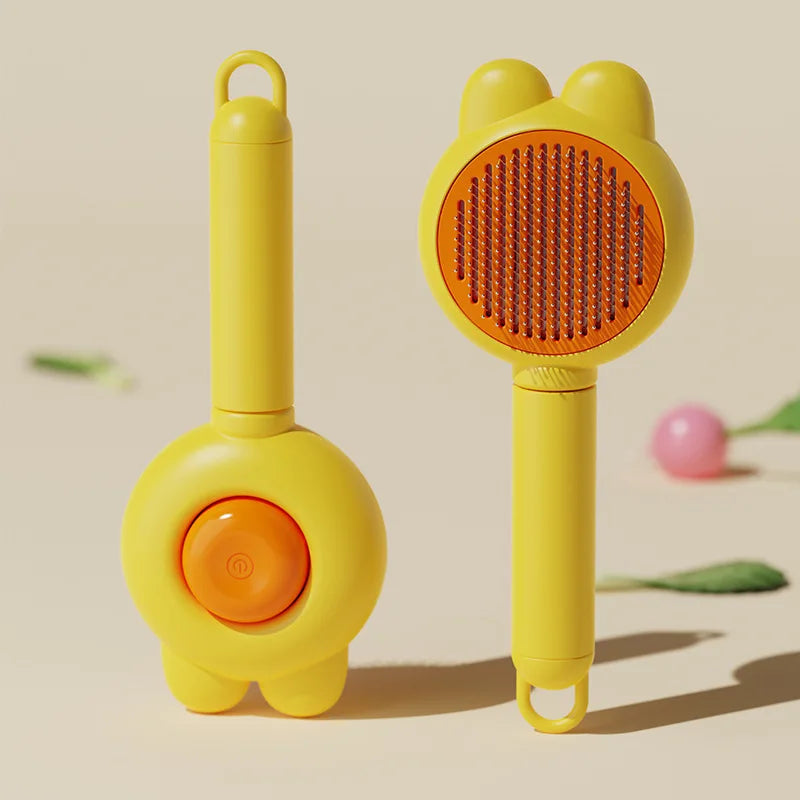 A yellow pet deshedding brush for cats and dogs with a self-cleaning design shown against a light background.