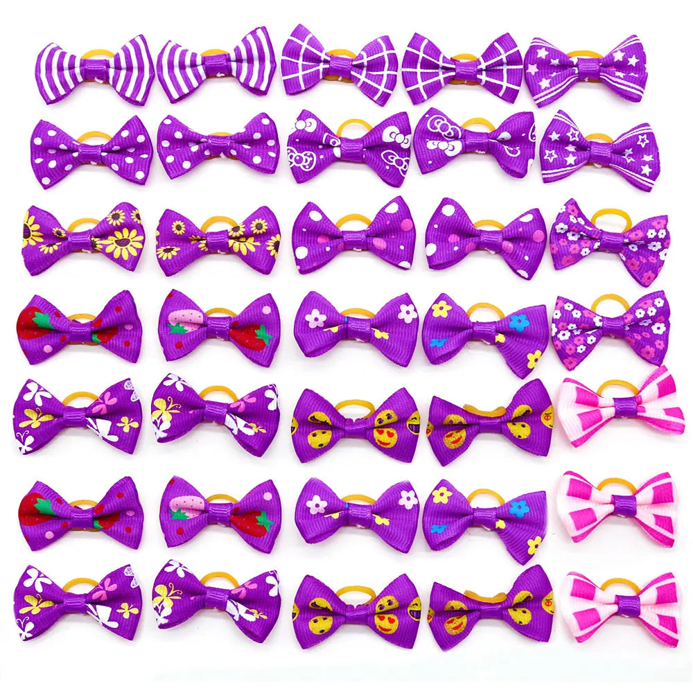 A collection of adorable pet hair bows in various colors and patterns with gentle rubber bands.