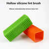 A green silicone lint brush and an orange silicone lint brush are shown diagonally on a white background.