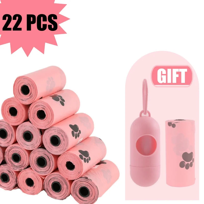 A stack of 22 rolls of pink biodegradable dog waste bags with a dispenser shown next to the product.