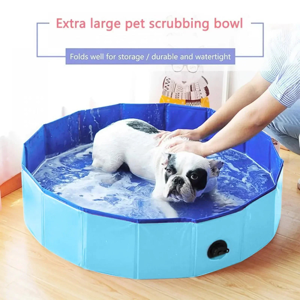 A white dog is bathing in a blue foldable pet scrubbing bowl or tub.
