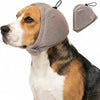 A dog wearing a gray calming headgear designed for comfort and anxiety relief.
