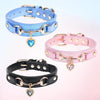 Three dog collars in blue, pink, and black leather with gold hardware and heart-shaped rhinestone charms.