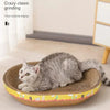 A gray kitten is resting on a woven cat scratching post with thick material edging.