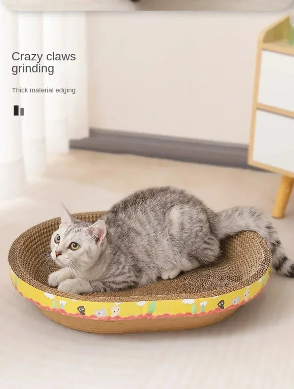 A gray kitten is resting on a woven cat scratching post with thick material edging.