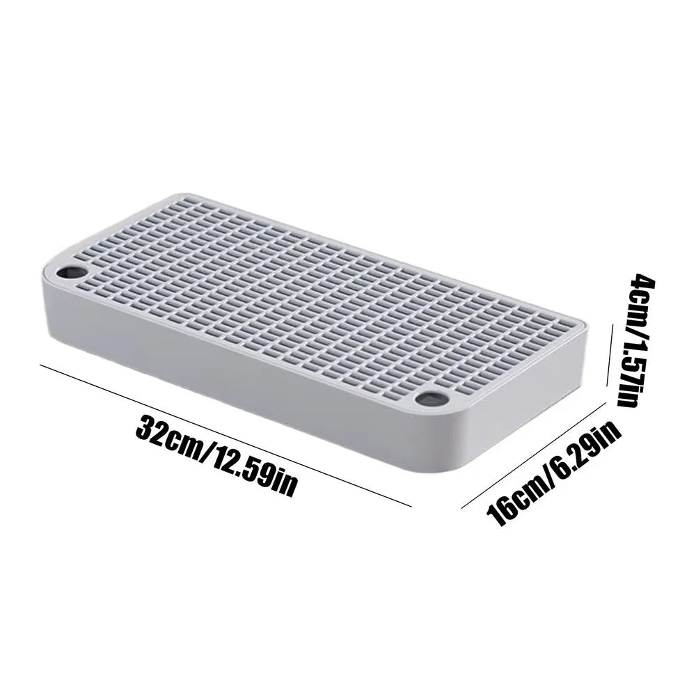 A rectangular white cat litter box ramp step with a grid pattern and filter tray.
