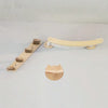 A wooden wall-mounted cat hammock and climbing shelf with a sisal scratching post.