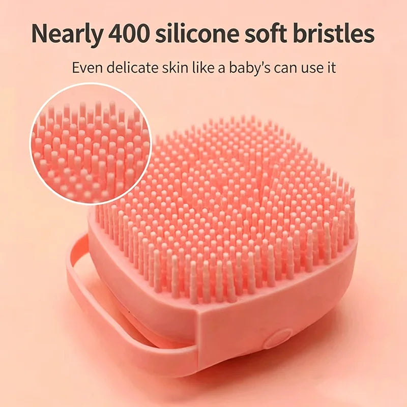 A pink silicone pet bath massage brush with soft bristles shown on a light background.