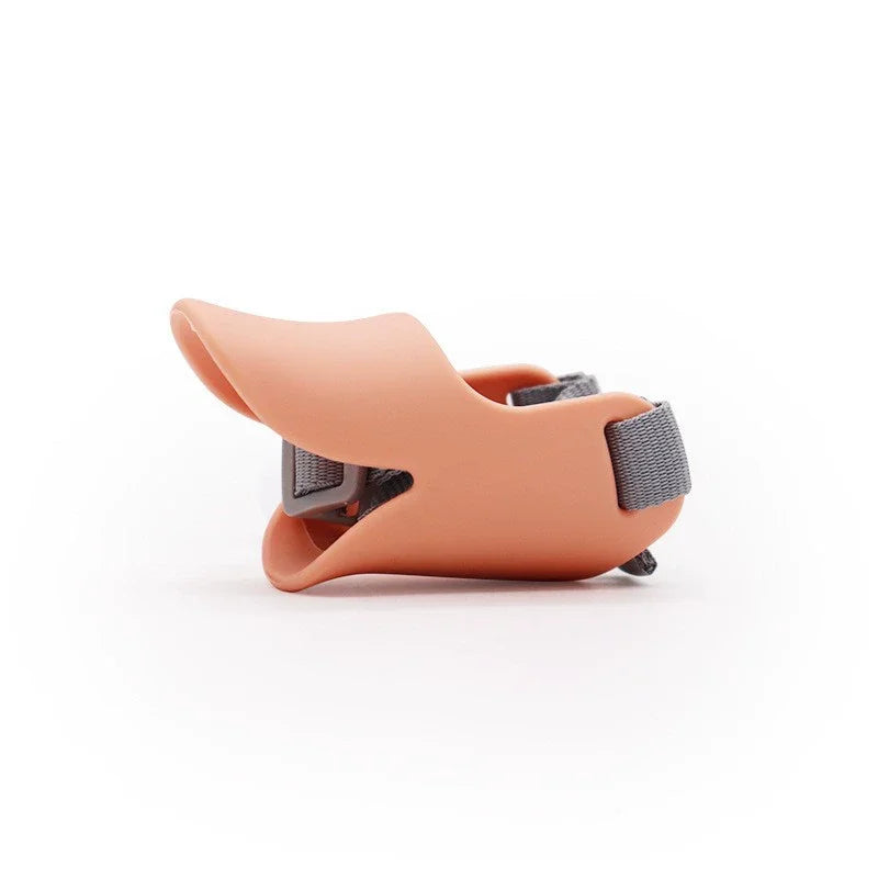 A soft silicone dog muzzle in a dusty rose color, shown from the side.